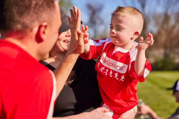 Little Kickers Coach giving a child a high-five